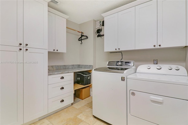 clothes washing area with cabinet space and washer and dryer