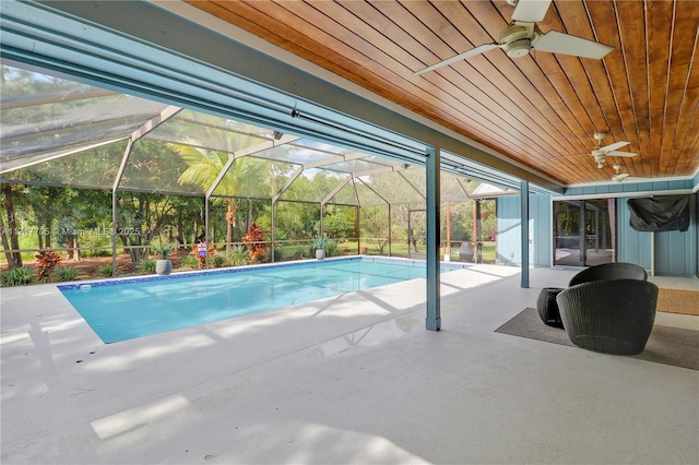 outdoor pool with a lanai, a patio area, and ceiling fan