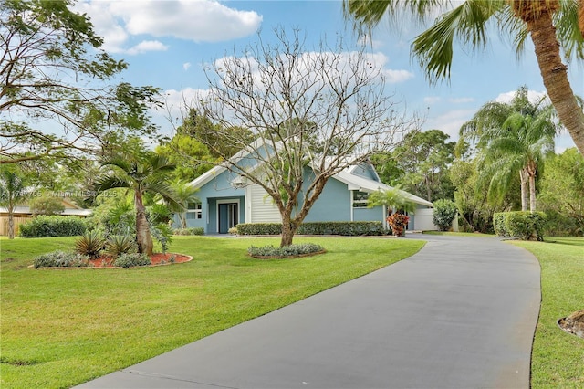 view of front of house with driveway and a front yard