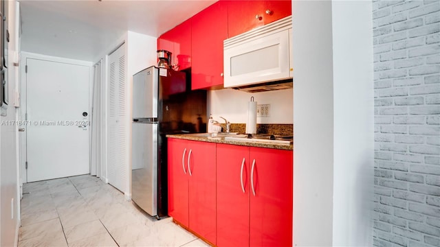 kitchen featuring sink and white appliances