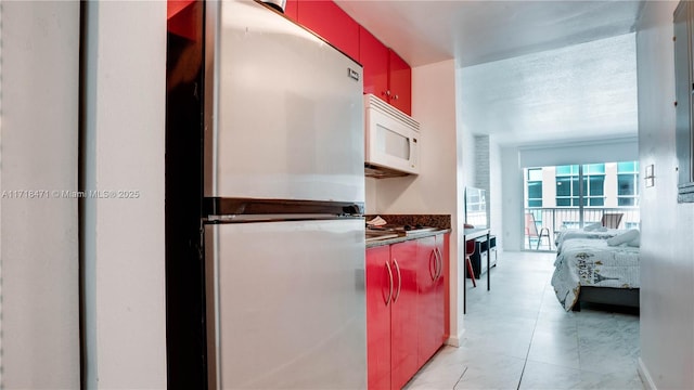 kitchen featuring stainless steel fridge and a textured ceiling