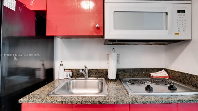 kitchen featuring white appliances and sink