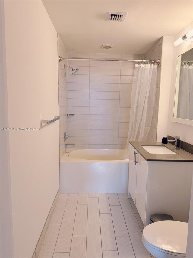 full bathroom with vanity, toilet, and shower / bath combo with shower curtain