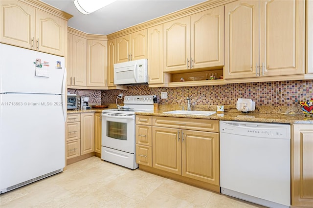 kitchen with light stone countertops, light brown cabinets, white appliances, and sink