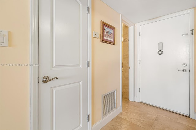 hall with light tile patterned floors