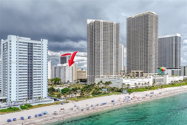 view of building exterior featuring a beach view and a water view