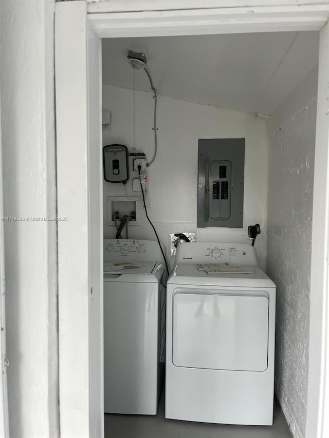 clothes washing area featuring independent washer and dryer and electric panel