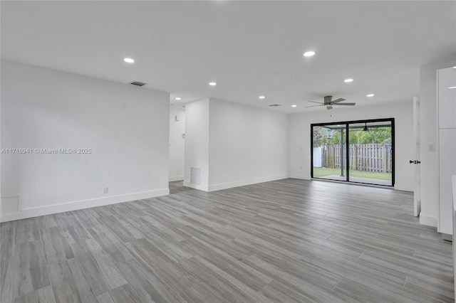 unfurnished room with ceiling fan and light hardwood / wood-style flooring