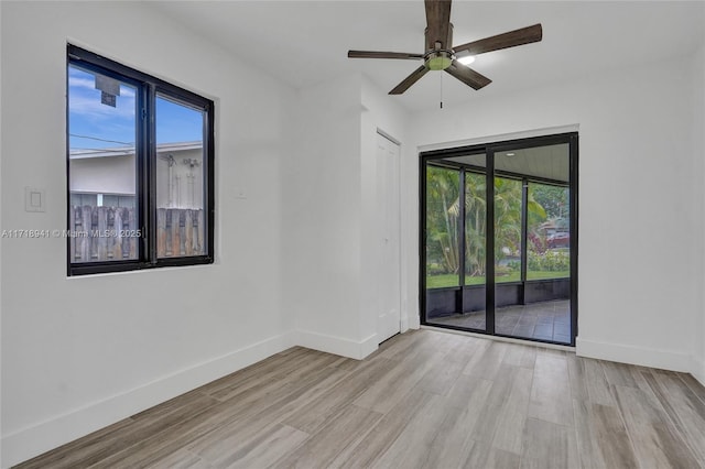 unfurnished room featuring ceiling fan and light wood-type flooring