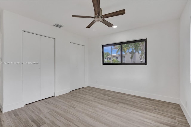 unfurnished bedroom featuring ceiling fan and light wood-type flooring