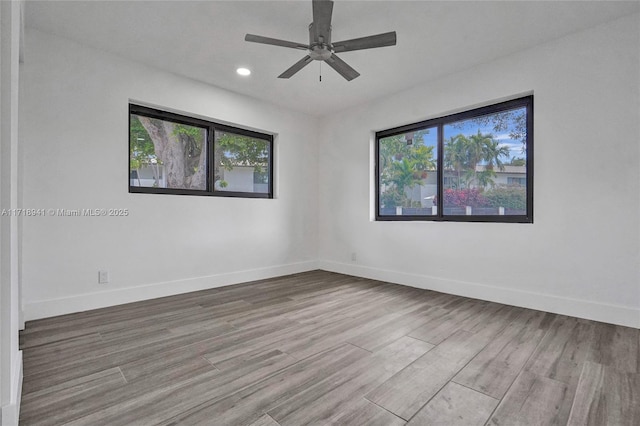 spare room featuring light hardwood / wood-style floors and ceiling fan