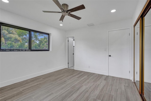 unfurnished bedroom with ceiling fan and light hardwood / wood-style floors