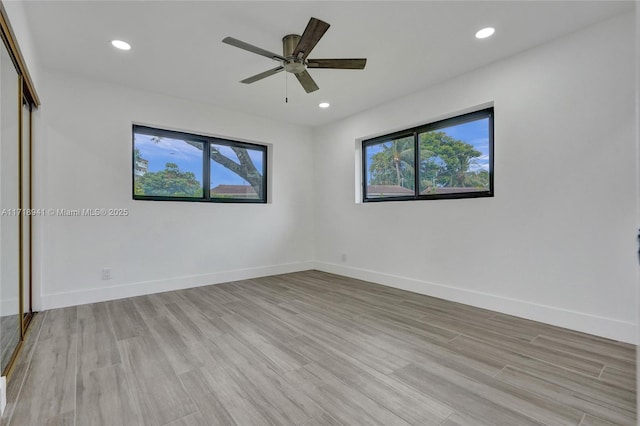 empty room with light hardwood / wood-style floors and ceiling fan