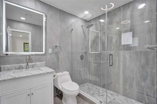 bathroom with vanity, tile walls, an enclosed shower, and toilet