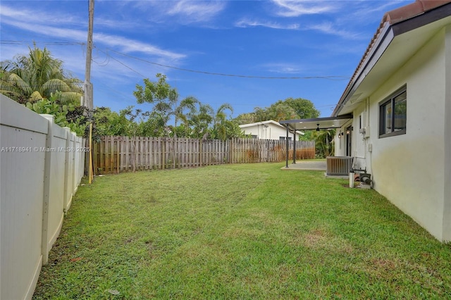 view of yard featuring a patio area and central air condition unit