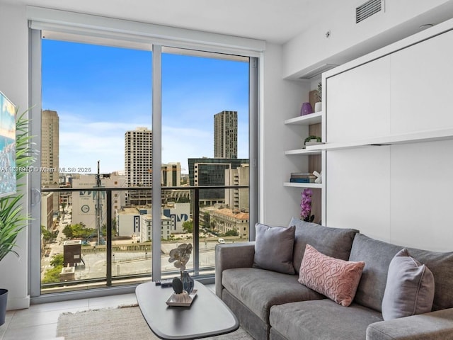 tiled living room with a wall of windows