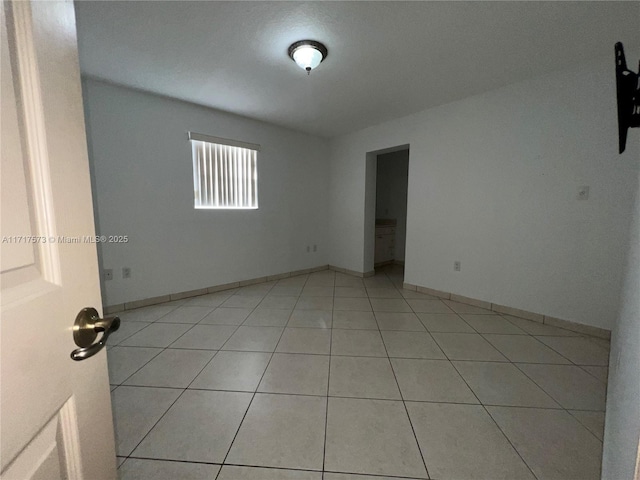 empty room with light tile patterned floors