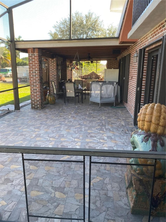 view of patio featuring a lanai