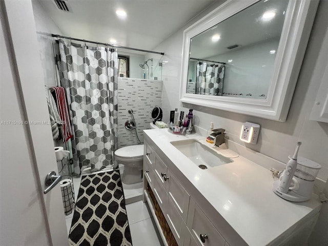 bathroom with a shower with shower curtain, vanity, tile patterned floors, and toilet