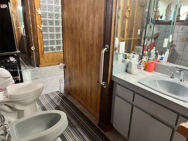 bathroom with vanity and a bidet