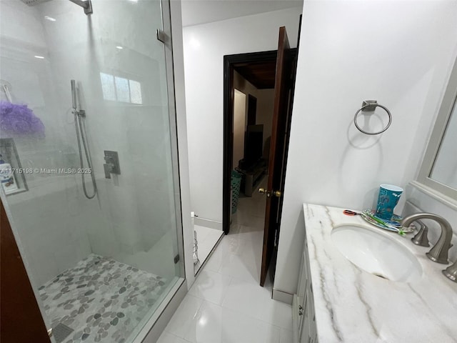 bathroom with tile patterned floors, vanity, and walk in shower