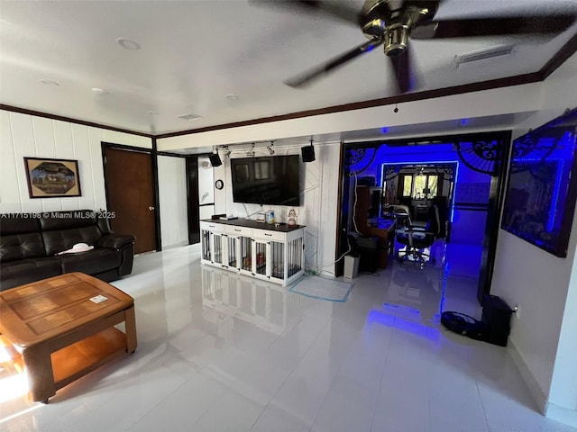 living room with ceiling fan, light tile patterned flooring, and ornamental molding