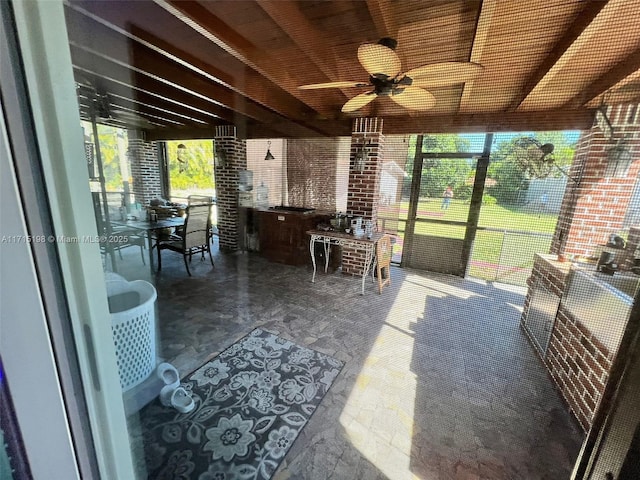 sunroom featuring ceiling fan