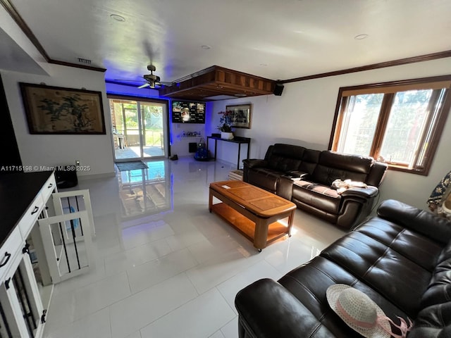 living room with ceiling fan, crown molding, and light tile patterned floors