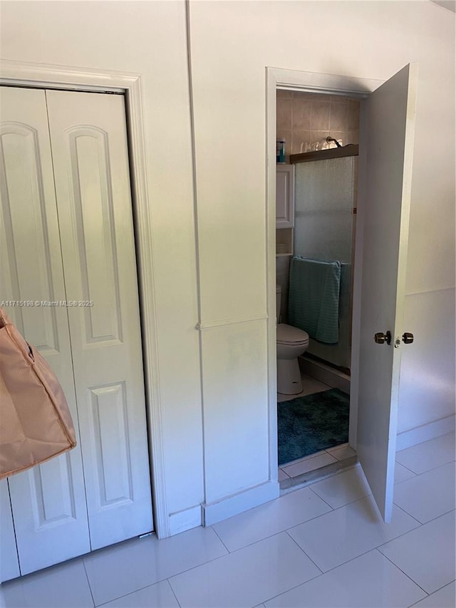 interior space featuring toilet and tile patterned floors