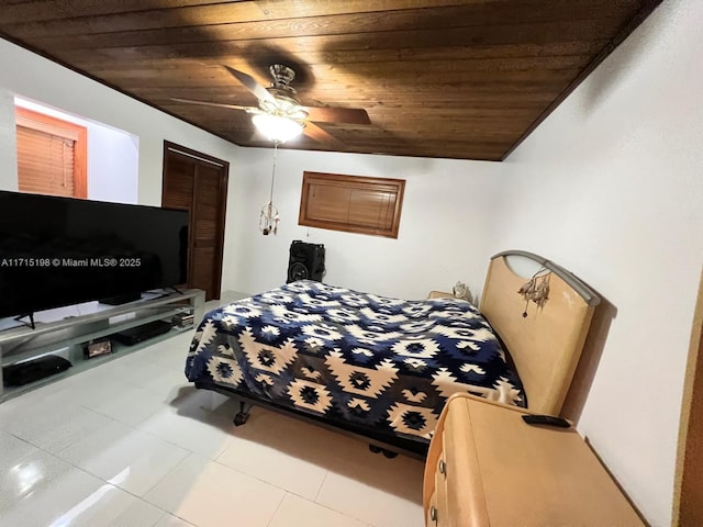 bedroom with a closet, vaulted ceiling, ceiling fan, and wooden ceiling