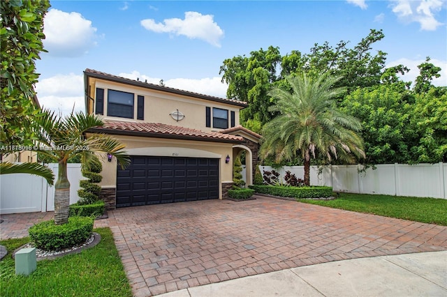 mediterranean / spanish house with a garage