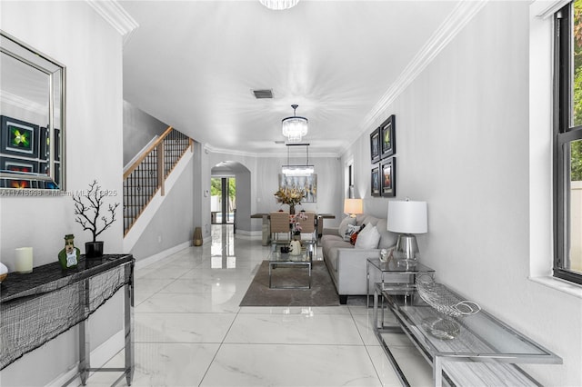 living room featuring a chandelier and crown molding