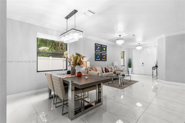 dining space featuring crown molding, plenty of natural light, and a notable chandelier