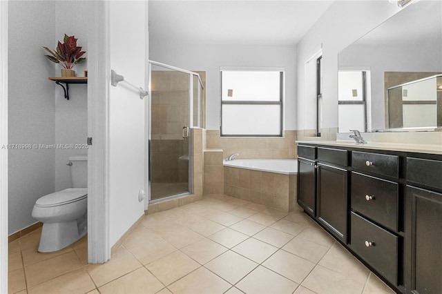 full bathroom with tile patterned flooring, vanity, shower with separate bathtub, and toilet