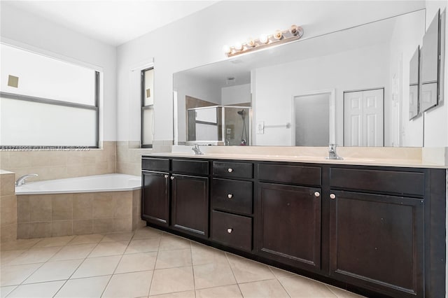 bathroom with tile patterned floors, vanity, and independent shower and bath