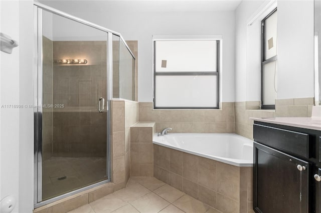 bathroom with tile patterned flooring, vanity, and separate shower and tub