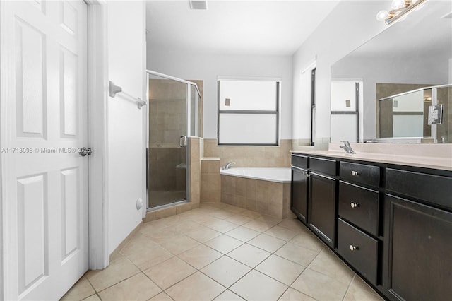 bathroom with tile patterned floors, separate shower and tub, and vanity