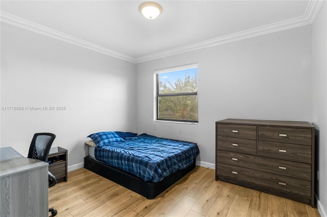 bedroom with light hardwood / wood-style floors and ornamental molding