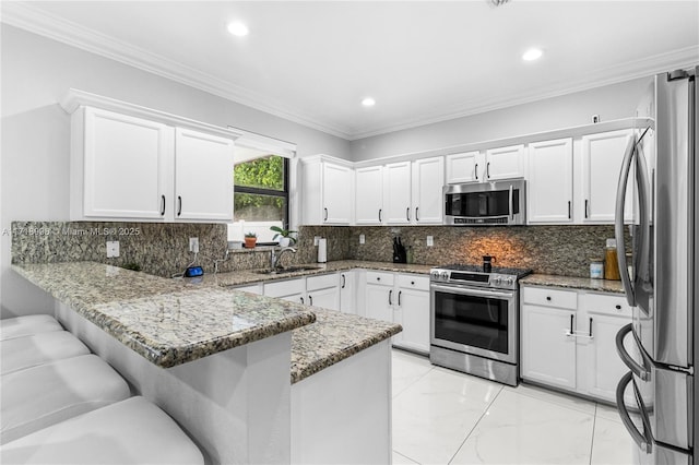 kitchen featuring white cabinetry, kitchen peninsula, light stone countertops, and stainless steel appliances