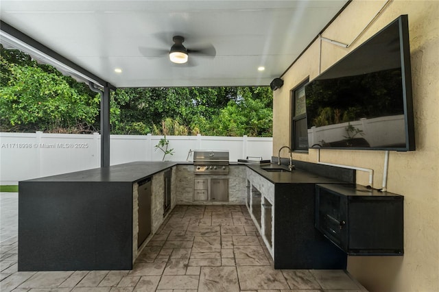 view of patio with an outdoor kitchen, area for grilling, ceiling fan, and sink