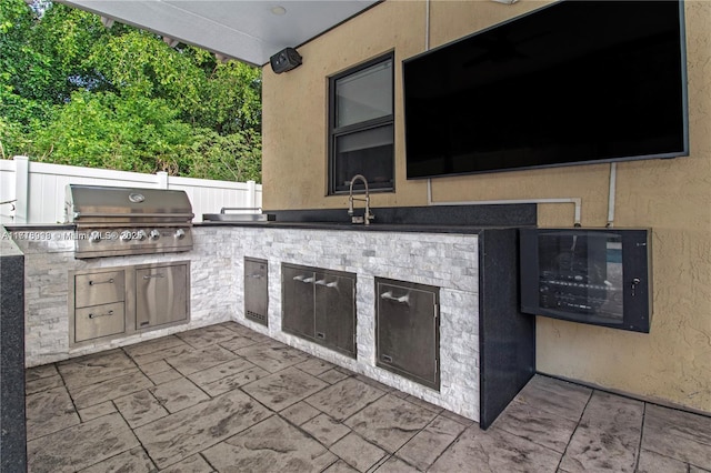 view of patio / terrace with grilling area and an outdoor kitchen