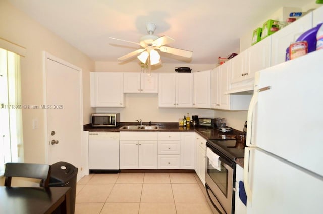 kitchen featuring appliances with stainless steel finishes, ceiling fan, sink, light tile patterned floors, and white cabinets