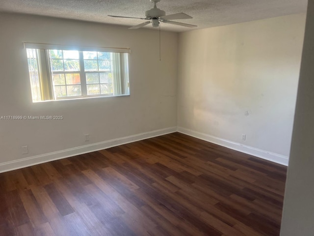 spare room with a textured ceiling, a ceiling fan, baseboards, and dark wood-style flooring