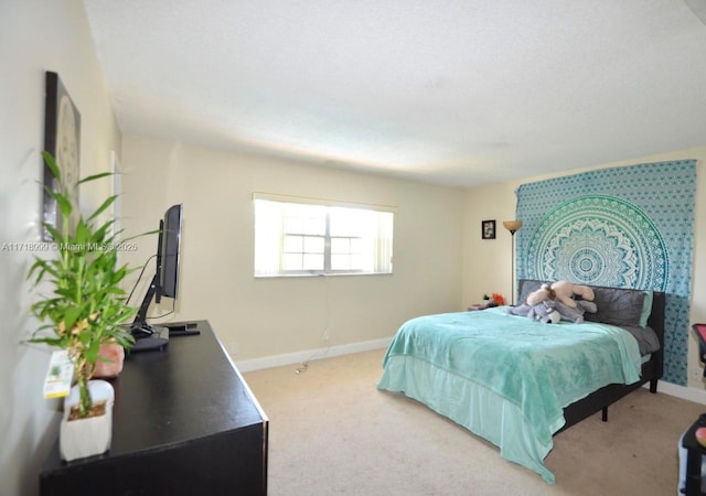 carpeted bedroom with baseboards