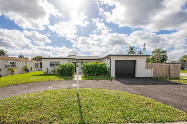 ranch-style home with a front lawn and a garage