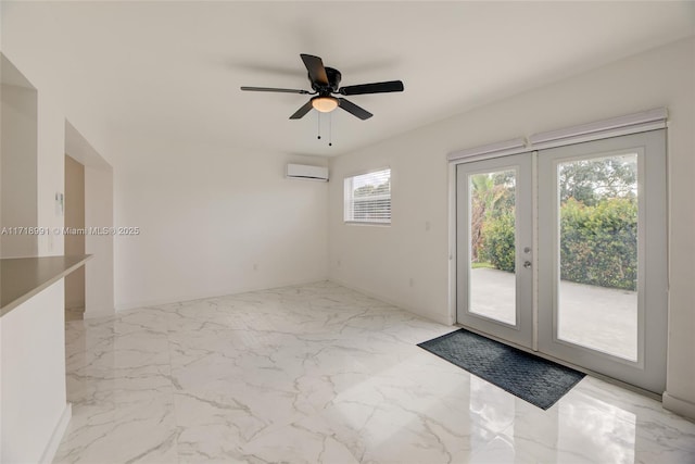 unfurnished room with a wall unit AC, ceiling fan, and french doors