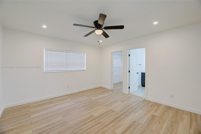 spare room with light wood-type flooring and ceiling fan