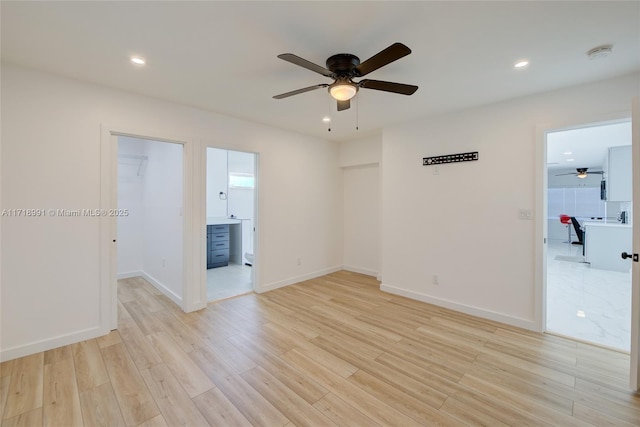 empty room featuring ceiling fan and light hardwood / wood-style floors