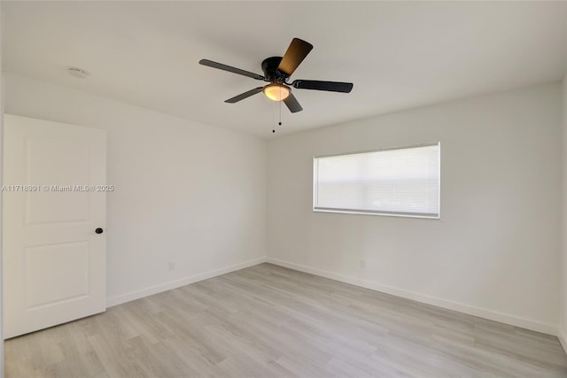 empty room with ceiling fan and light hardwood / wood-style flooring