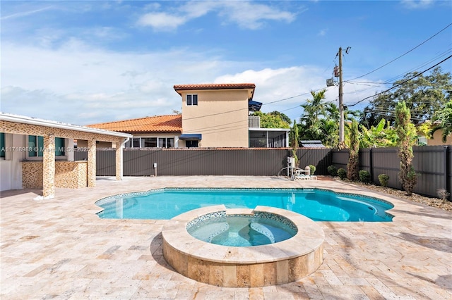 view of swimming pool with an in ground hot tub and a patio